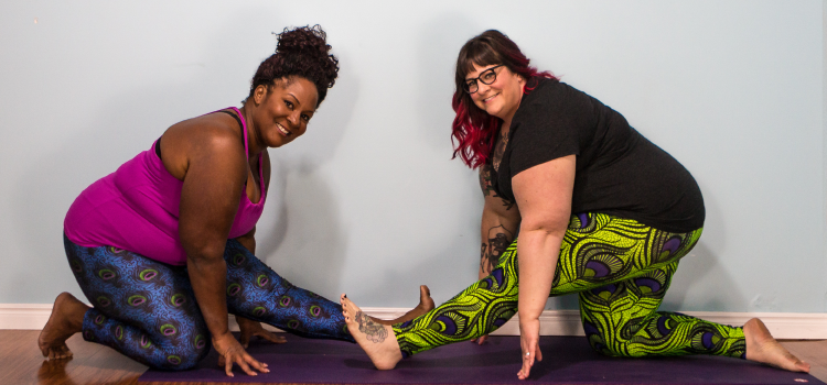 Dianne Bondy and Amber Karnes demonstrate a yoga pose.